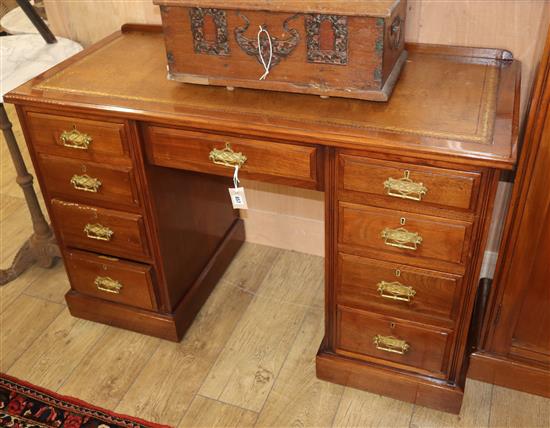 A late Victorian mahogany kneehole desk of nine drawers W.122cm